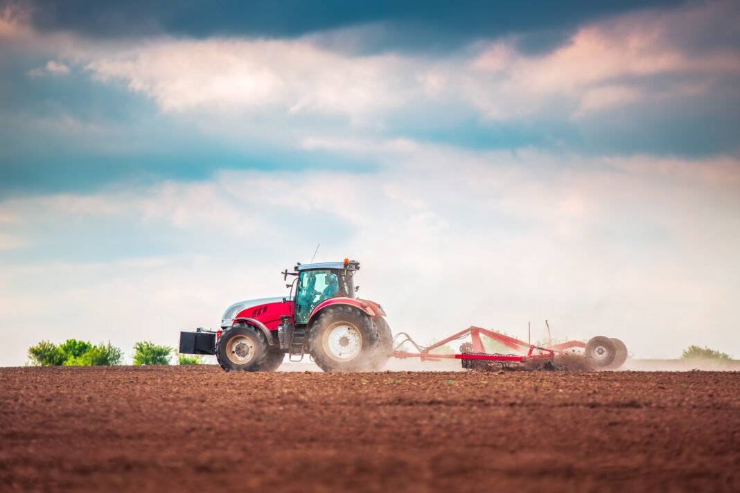 Farmer,In,Tractor,Preparing,Land,With,Seedbed,Cultivator