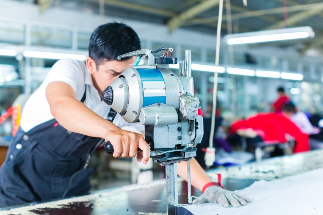 Indonesian,Worker,Using,A,Cutter,-,A,Large,Machine,For