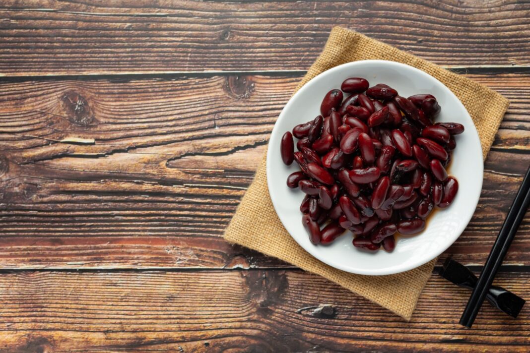 red bean boiled in white plate place on wooden floor
